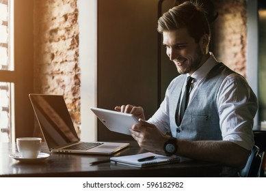 Young Man Drawing Template For The Web Site Associated With Digital Marketing, Current Trends And Tendencies Of UX / UI Design. Businessman Who Rules His Company Remotely, Like A Freelancer