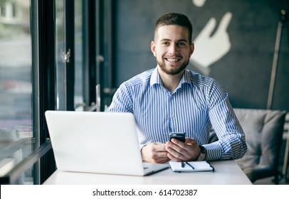 Young man drawing template for the web site associated with digital marketing, current trends and tendencies of UX / UI design. Businessman who rules his company remotely, like a freelancer