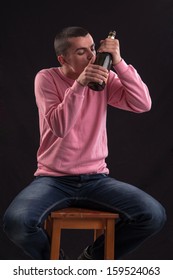 Young Man Drinking Alcohol And Kissing Glass