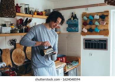 Young Man Drinking Coffee In His Kitchen