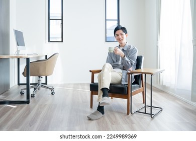 Young man drinking coffee at home - Powered by Shutterstock