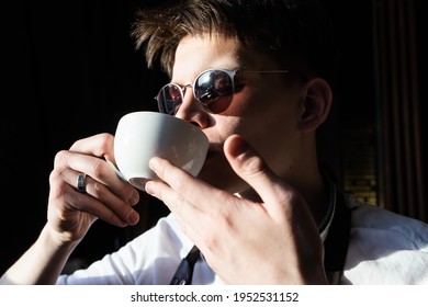 Young Man Drinking Coffee Or Tea. Barista Tasting Coffee