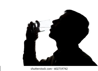 Young Man Drinking A Glass Of Sparkling Water - Silhouette