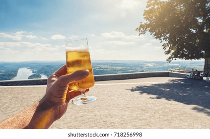 Young Man Drinks Fresh Beer In A Beer Garden At Summer