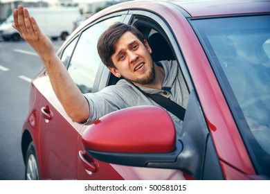 The Young Man Driving The Car Angry, Stuck In A Traffic Jam