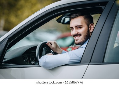 Young Man Driving A Car Smiling