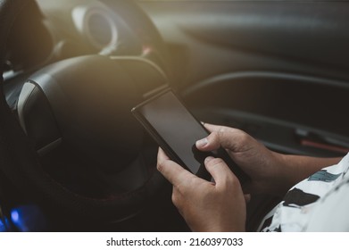 Young Man Driving Car And Using Mobile Phone