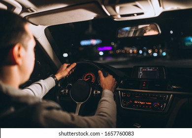 Young Man Driving His Car At A Night Time