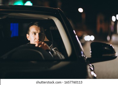 Young Man Driving His Car At A Night Time