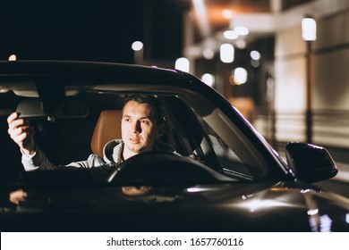 Young Man Driving His Car At A Night Time