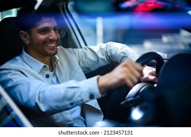 Young Man Driving His Car At Night