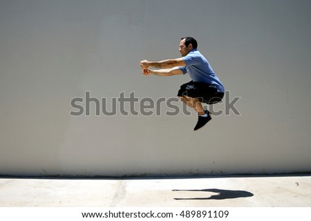 Similar – Athletic man warming up before running.