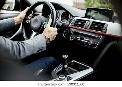 Young Man Driving In The  Modern Car