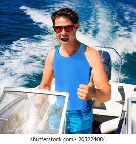 Young Man Driving A Speedboat