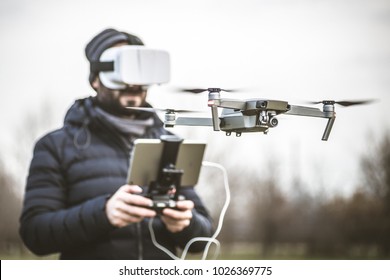 Young man with drone and virtual reality viewer
