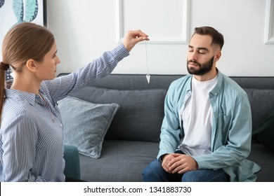 Young Man During Hypnosis Session In Psychologist's Office