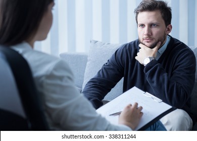 Young Man During Therapy At Psychologist's Office