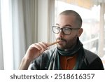 Young Man eating breadstick snack