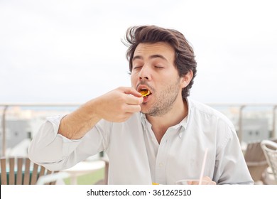 Young Man Eating Chips