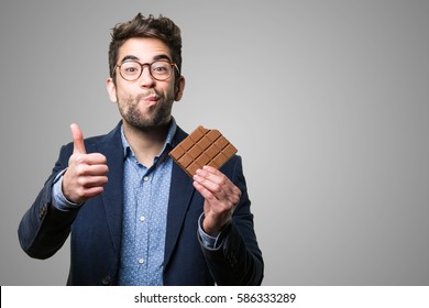 Young Man Eating A Chocolate Bar