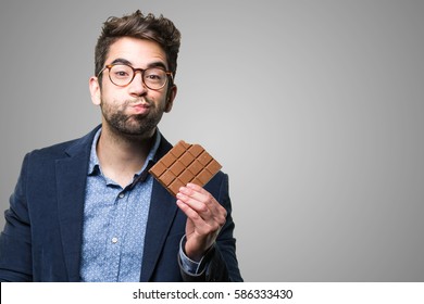 Young Man Eating A Chocolate Bar