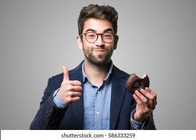 young man eating a chocolate donut