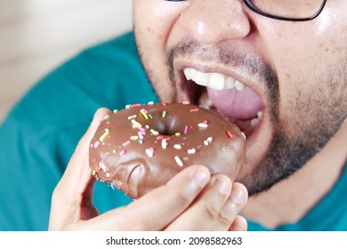  young man eating donut , selective focus 