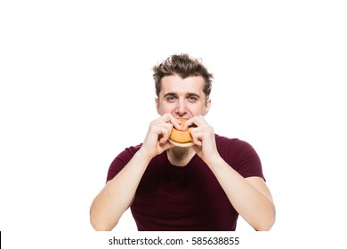 Young Man Eating A Fast Food Hamburger Isolated On White