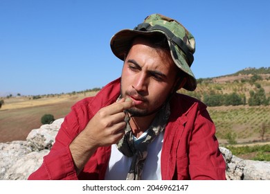 Young Man Eating Grapes In The Vineyard