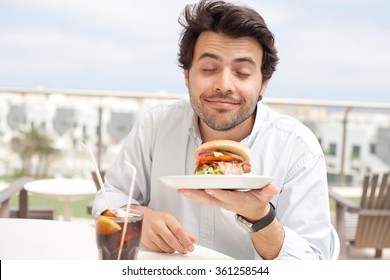 Young Man Eating A Hamburger