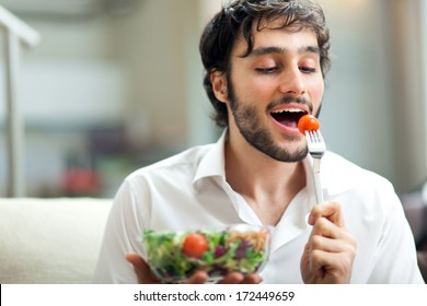 Young Man Eating A Healthy Salad 