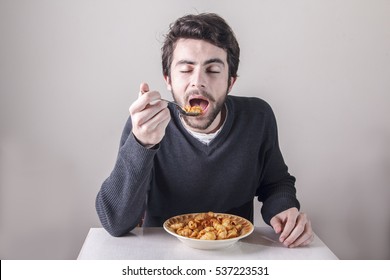 Young Man Eating His Pasta Food Ravenously