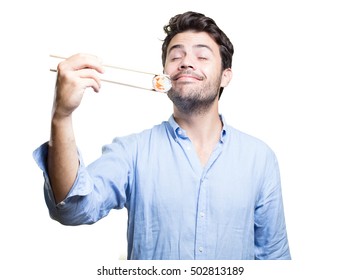 Young man eating sushi on white background