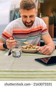 Young Man Eating Vegan Food Outdoors