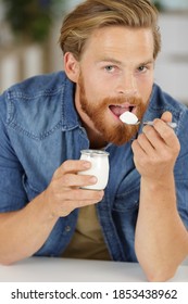 A Young Man Eating Yogurt