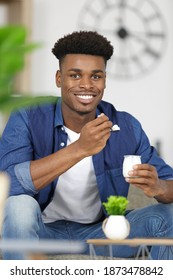 A Young Man Eating Yogurt