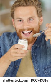 A Young Man Eating Yogurt