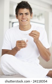 Young Man Eating Yogurt