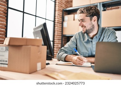 Young man ecommerce business worker using laptop writing on notebook at office - Powered by Shutterstock