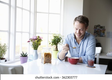 Young Man Enjoying Eating Breakfast