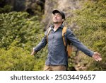 Young man enjoying nature, breathing deeply the fresh air. Let