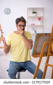 Young Man Enjoying Painting At Home