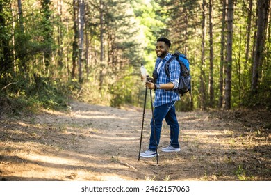 Young man enjoys  hiking and drinking energy drink. - Powered by Shutterstock