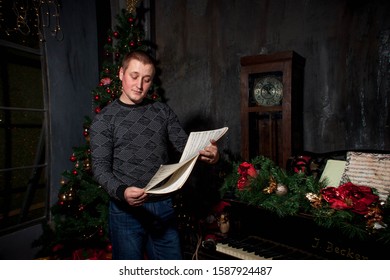 a young man examines the notes