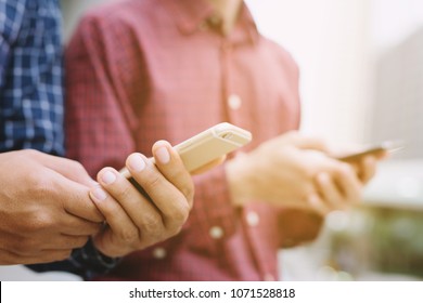 Young Man Exchange Call Mobile Smart Phone Number And Send Message. Share Connect Bluetooth Or Close Up Of Hands Two Man. Copy Leave Space For Text. Social Distancing. New Normal.