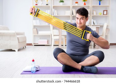 Young Man Exercising At Home In Sports And Healthy Lifestyle Con