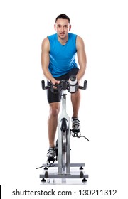 Young Man Exercising On A Bike,  Spinning Exercise Class