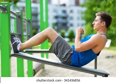 Young Man Exercising At Outdoor Gym
