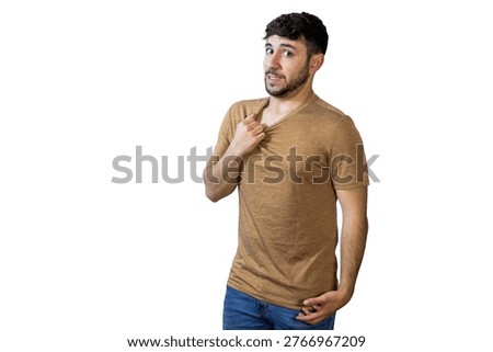 Young man experiencing excessive sweating, pulling his t-shirt away from his chest on a white background