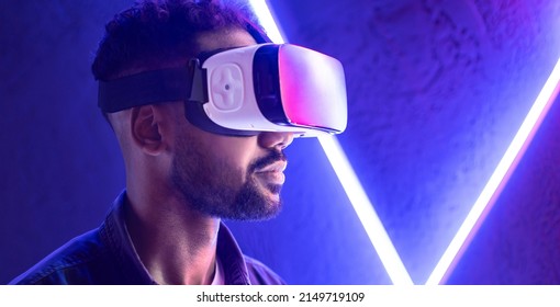 Young man experiencing virtual reality headset. VR, future, gadgets, meta verse, technology, education online, studying, video game concept